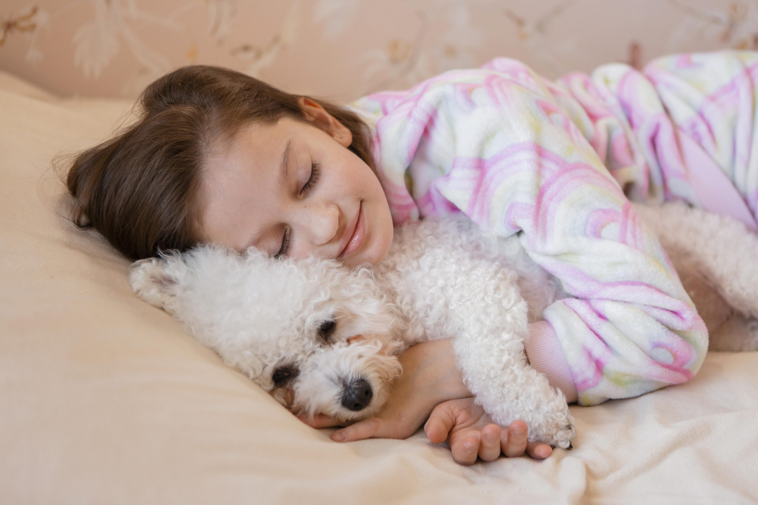 girl hugging her dog bed while sleeping